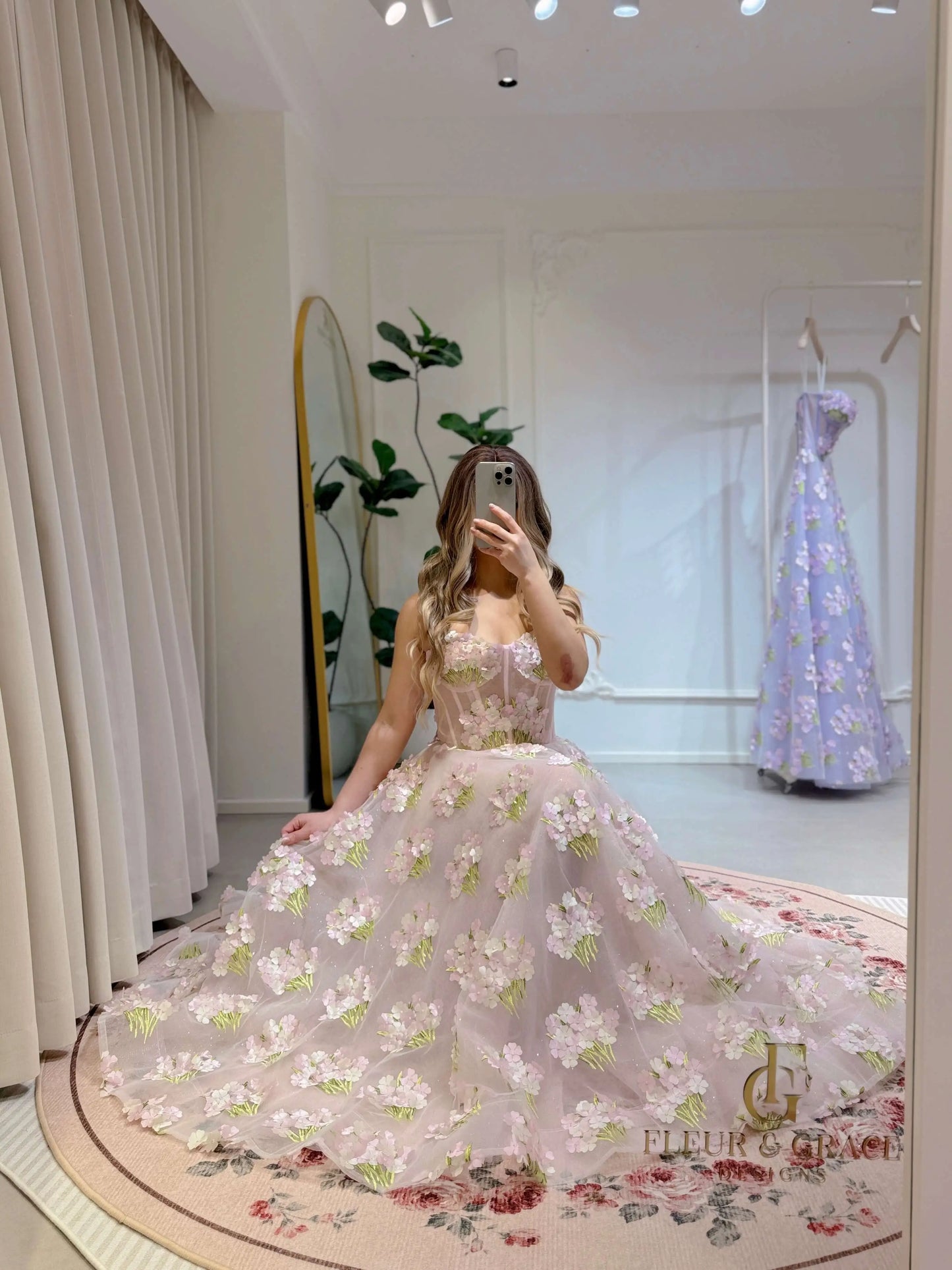 Model wearing the Elysia gown by Fleur&Grace Designs, a pink ankle-length dress made with 3D hydrangea floral lace, sparkly mesh lining, and lace-up back – perfect for prom, formal events, garden weddings, and whimsical photography.