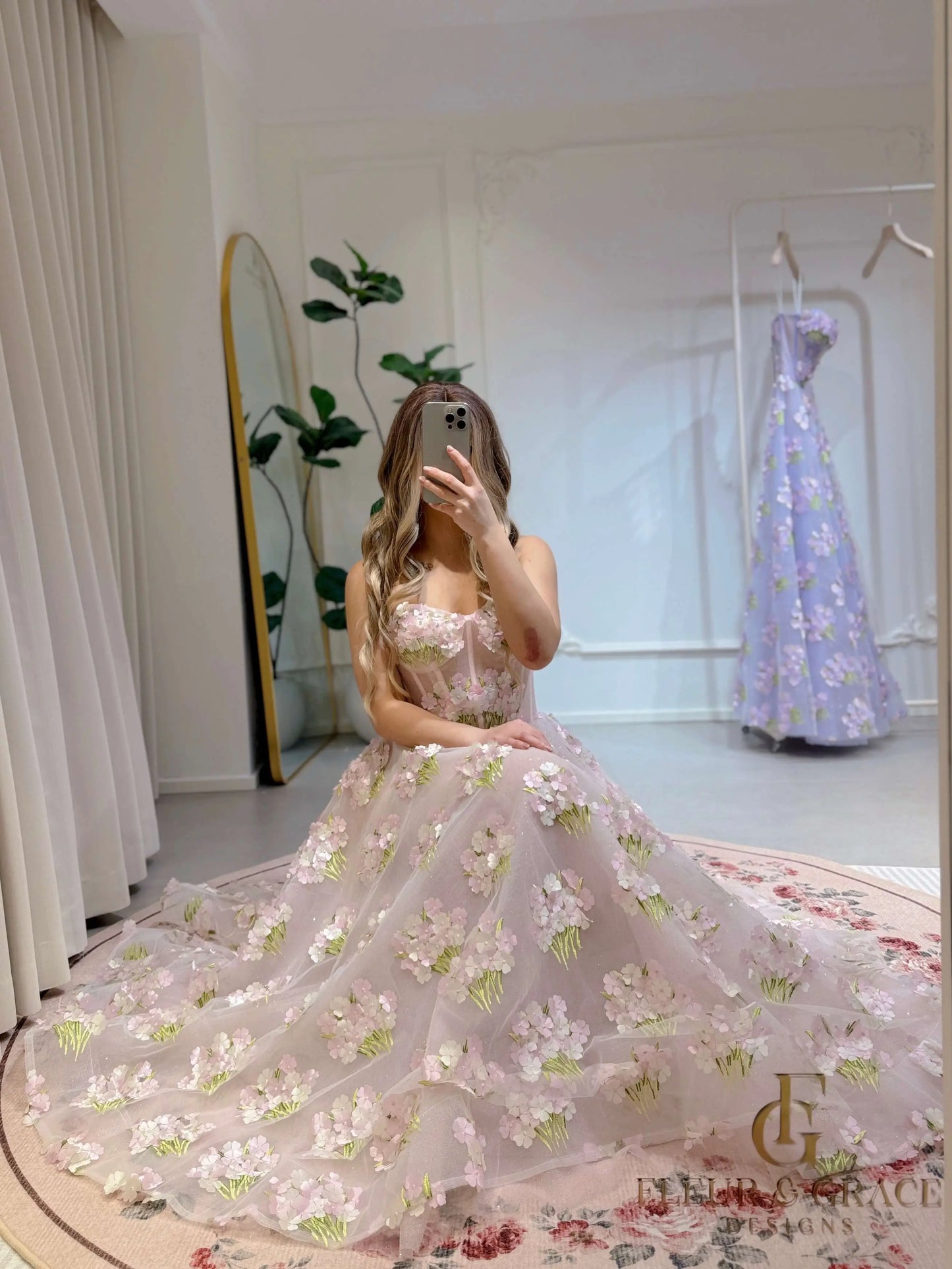 Model wearing the Elysia gown by Fleur&Grace Designs, a pink ankle-length dress made with 3D hydrangea floral lace, sparkly mesh lining, and lace-up back – perfect for prom, formal events, garden weddings, and whimsical photography.