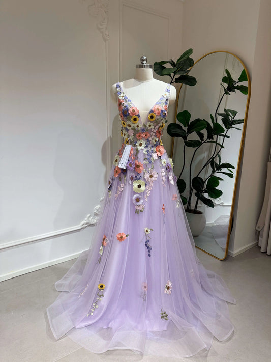 Lavender V-neck formal gown with floral embroidery, sparkly tulle skirt, and boned bodice on a mannequin.