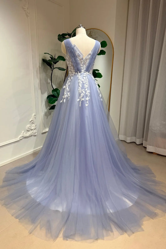 Dusty blue A-line wedding gown with a V-neck, tulle skirt, and intricate white floral lace appliqué on a mannequin.
