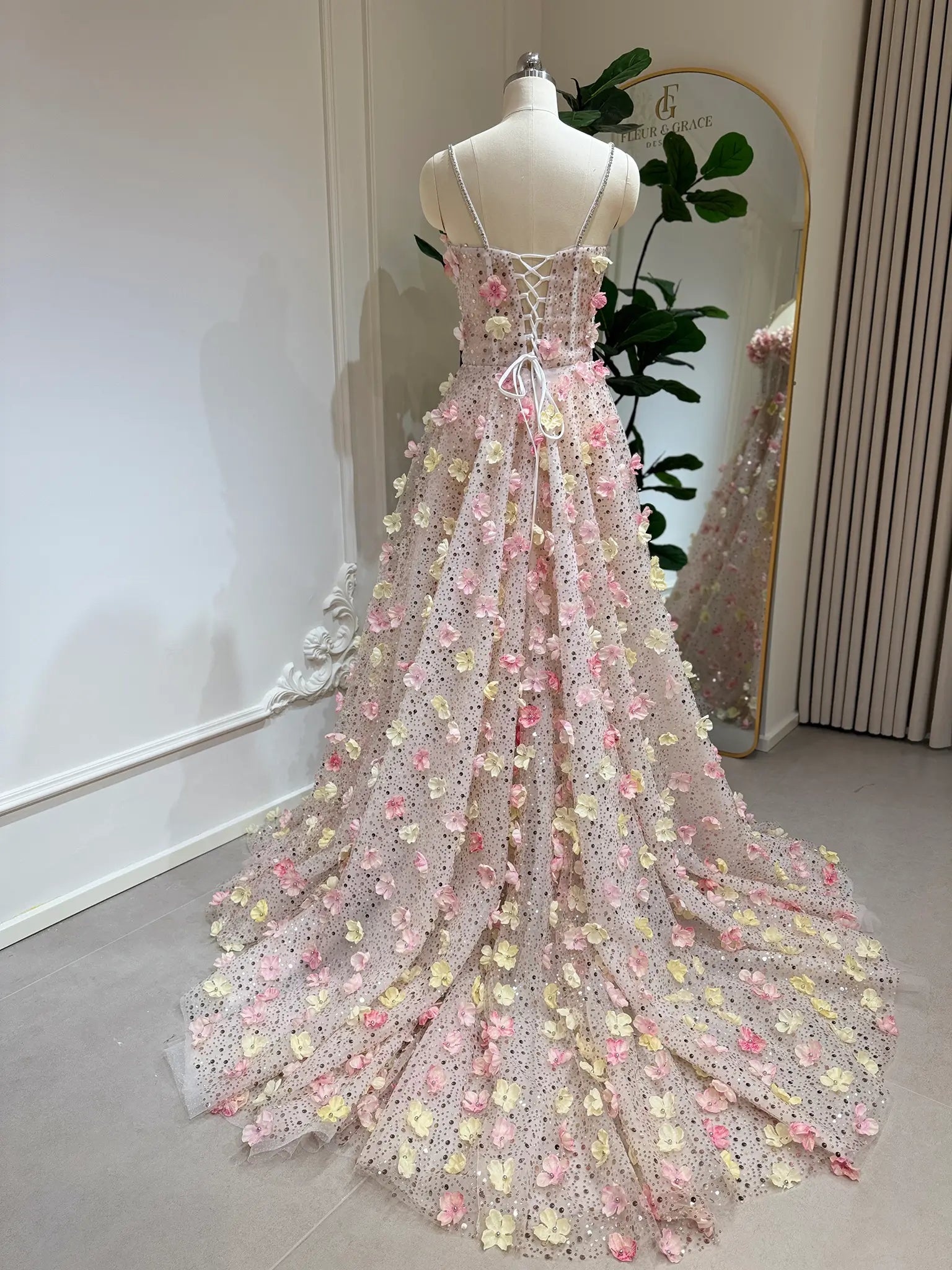 Alice Gown featuring pink and yellow 3D floral lace, a lace-up back, stone-accented straps, and a flowing court train.