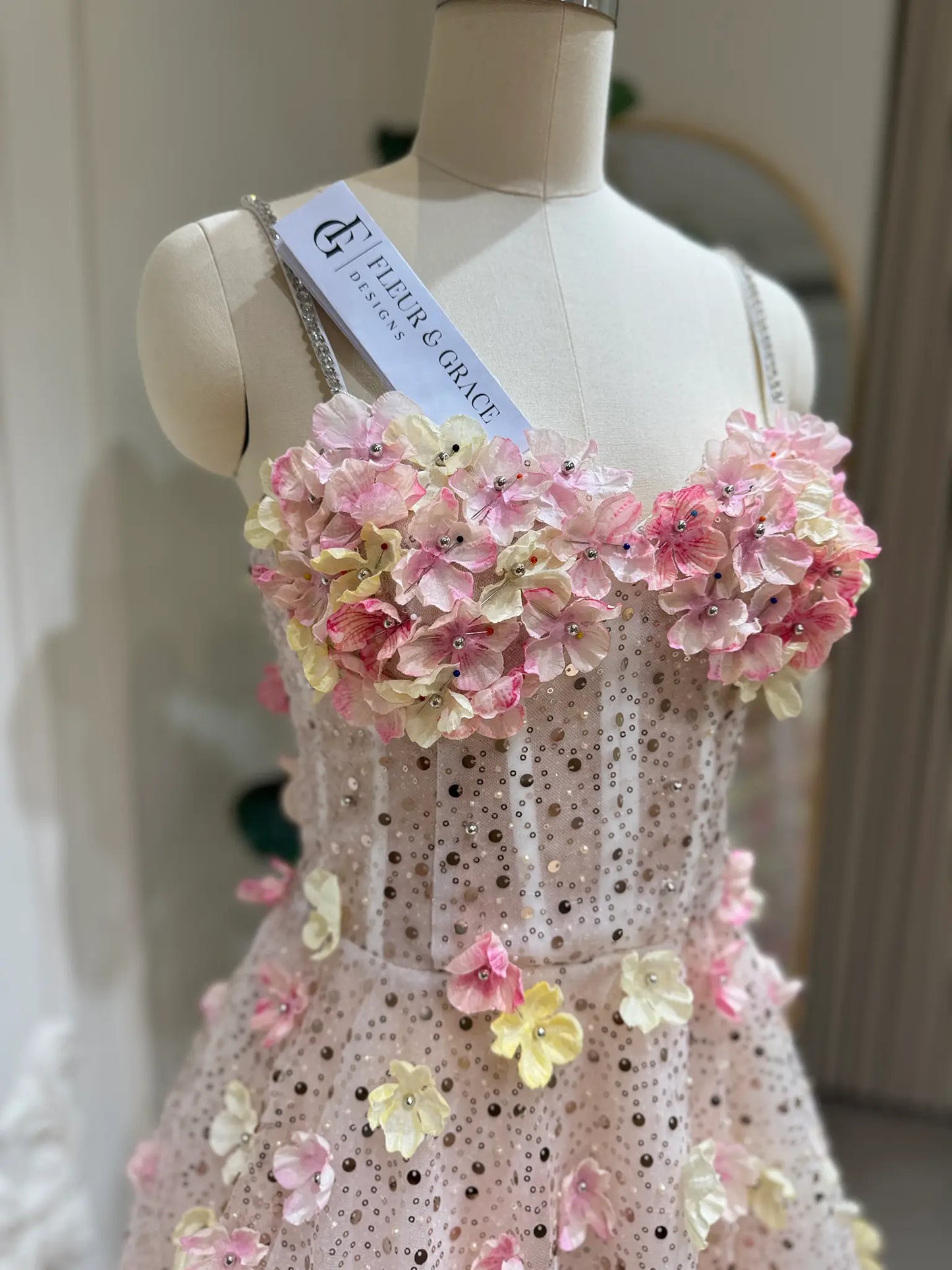 Alice Gown featuring pink and yellow 3D floral lace, sweetheart neckline, and sparkling stone-accented straps on a mannequin.