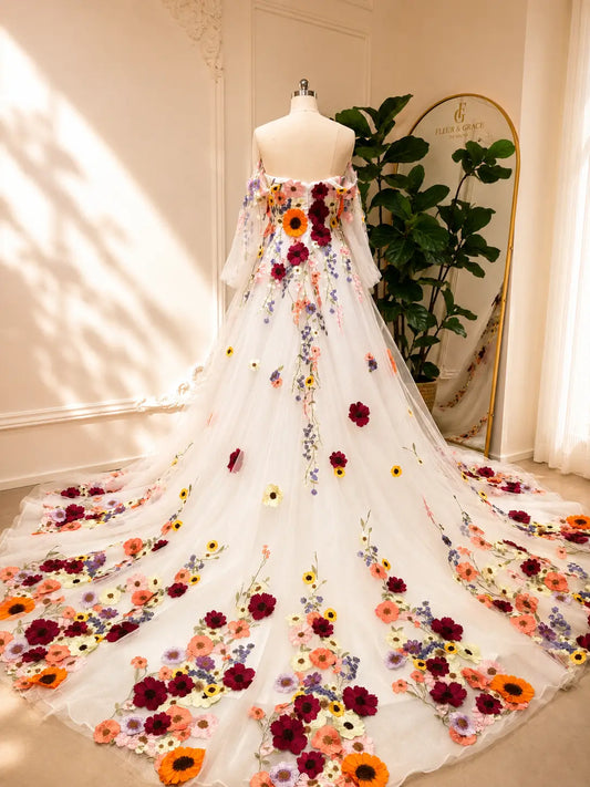A-line wedding dress with off-the-shoulder sleeves, featuring vibrant 3D floral appliqués on white sparkle tulle.