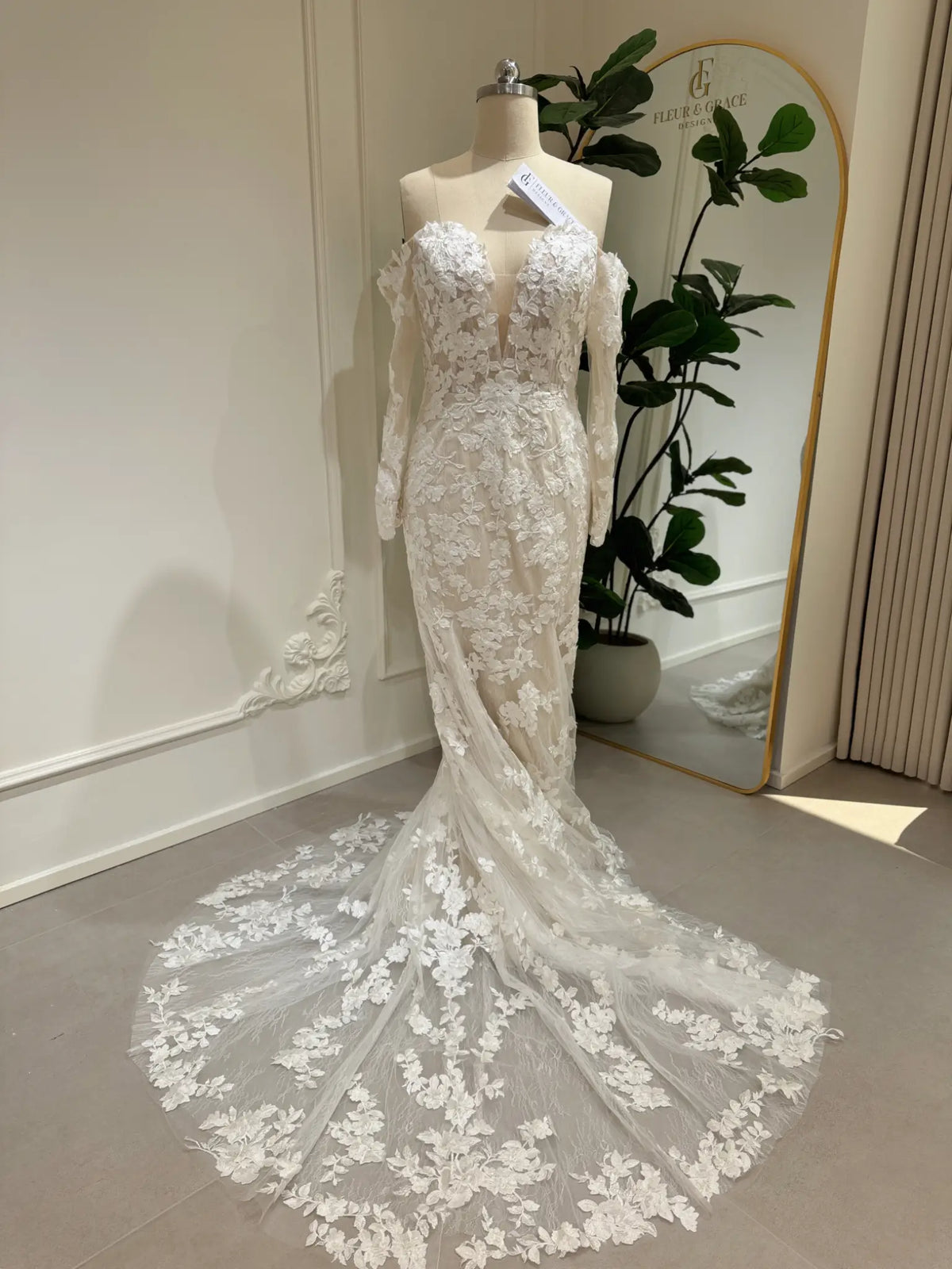 Ayla mermaid wedding dress with floral embroidery, off-the-shoulder long sleeves, and a plunging sweetheart neckline.