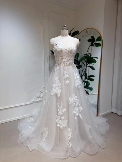 Strapless A-line wedding dress with a sweetheart neckline, 3D floral lace appliqués, and a flowing tulle skirt.