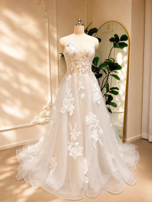 Strapless A-line wedding dress with 3D floral lace appliqués on a sweetheart bodice and flowing tulle skirt.
