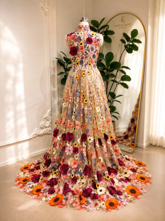 High-neck A-line wedding dress featuring colorful 3D floral embroidery on sheer tulle with a dramatic sweeping train.