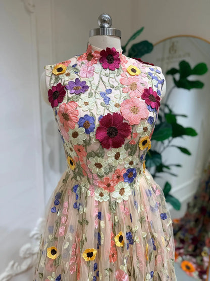 High-neck wedding dress featuring colorful 3D floral embroidery on a sheer tulle bodice and A-line skirt.