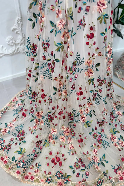 A-line wedding dress with sheer tulle featuring embroidered pink, burgundy, and green floral lace patterns.