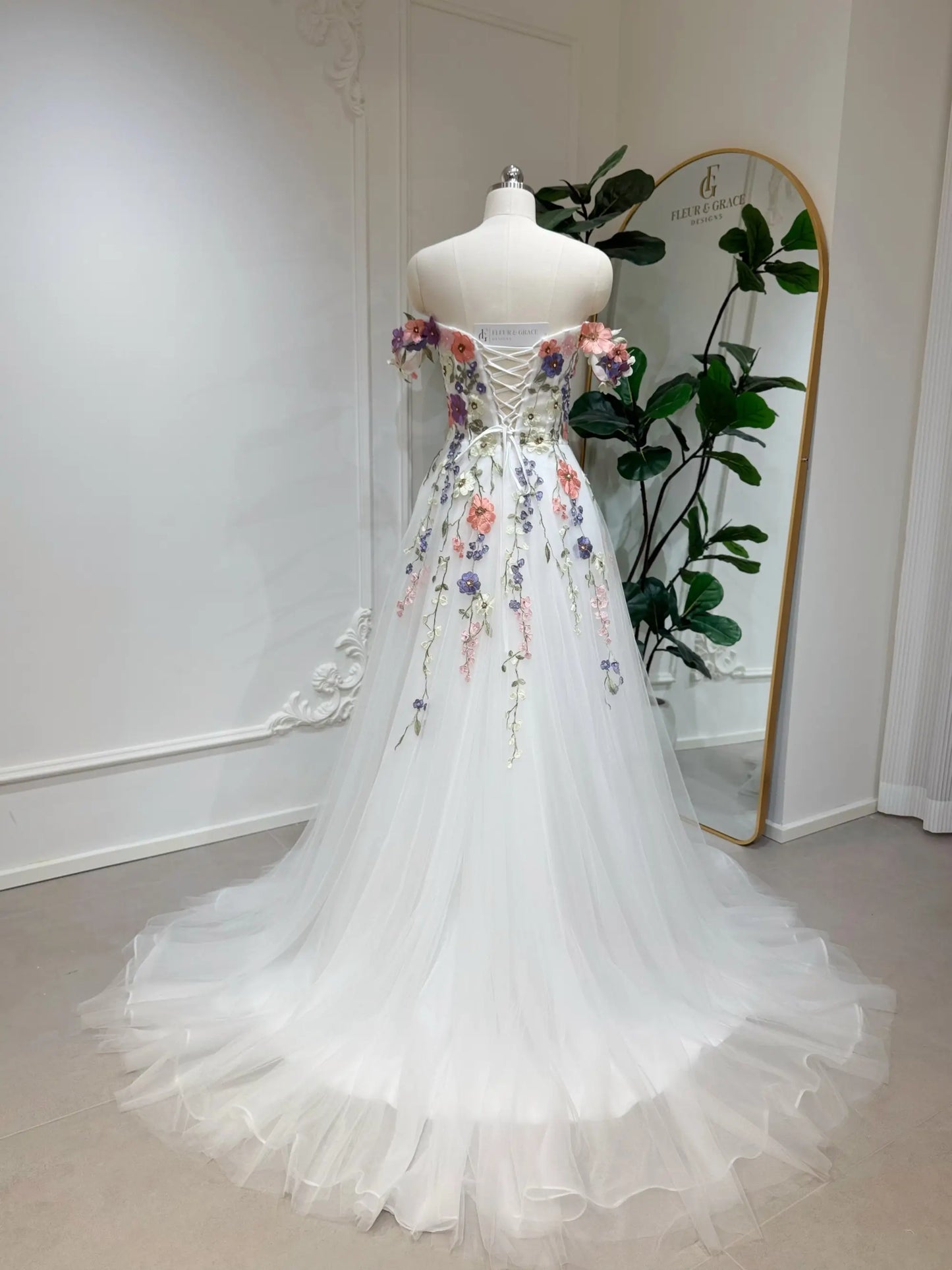 Fleur Grace Designs Fiona floral wedding dress with 3D appliqué flowers, off-shoulder neckline & tulle A-line skirt. Matching veil available