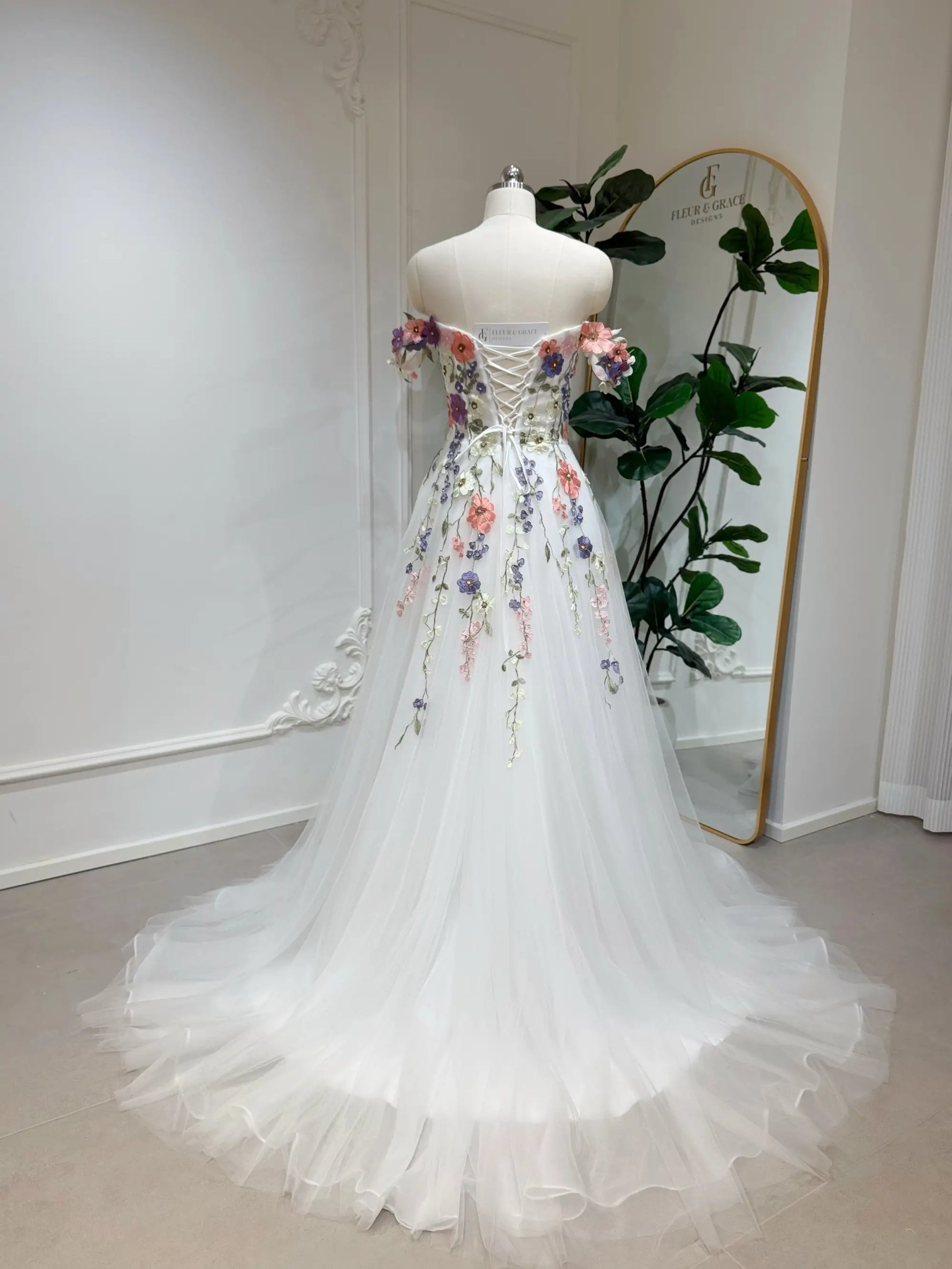Fleur Grace Designs Fiona floral wedding dress with 3D appliqué flowers, off-shoulder neckline & tulle A-line skirt. Matching veil available