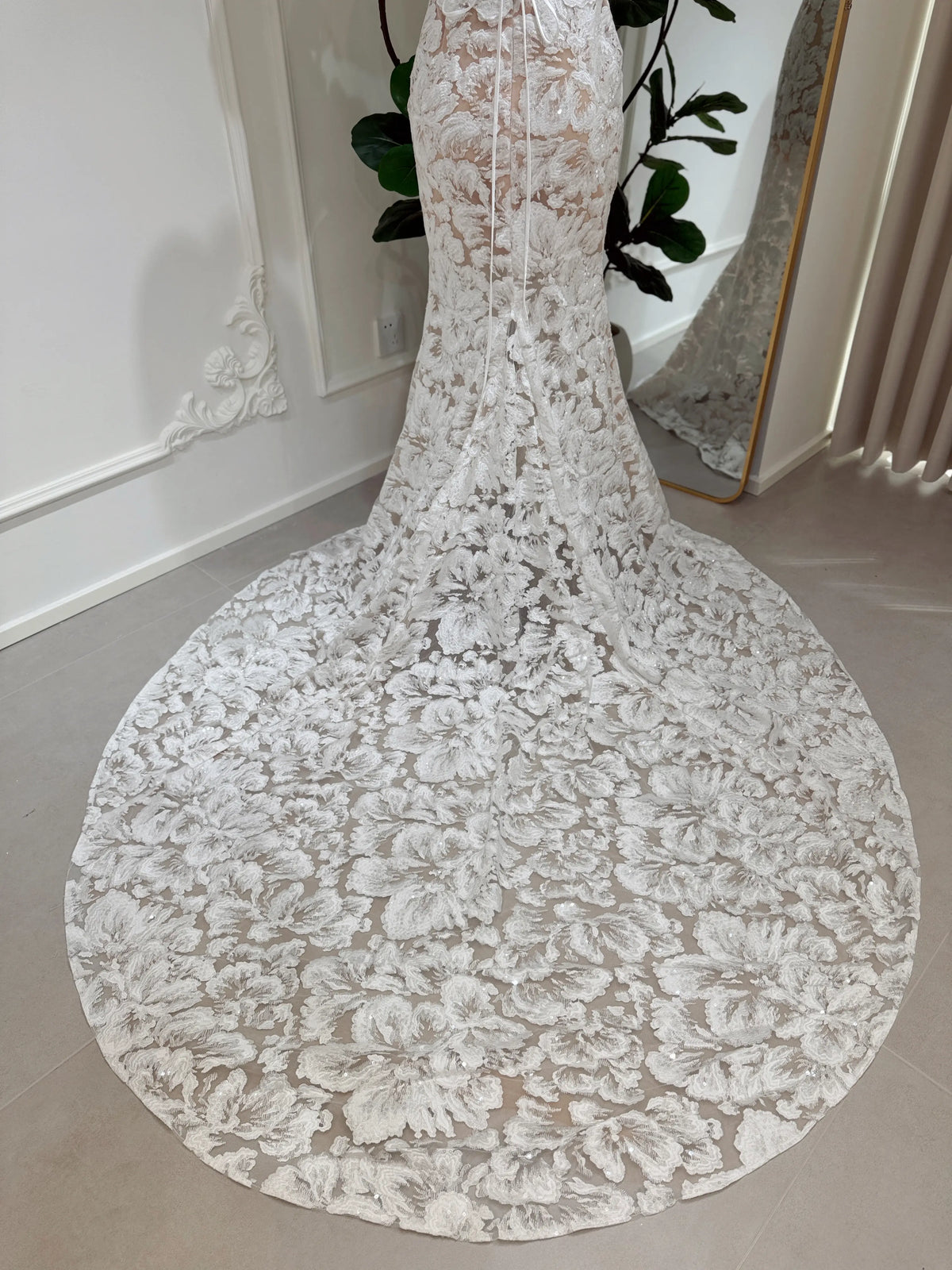 Mermaid wedding dress with floral embroidered lace, glitter sequins, and a dramatic chapel-length train.
