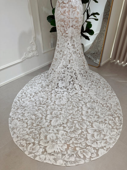 Mermaid wedding dress with floral embroidered lace, glitter sequins, and a dramatic chapel-length train.
