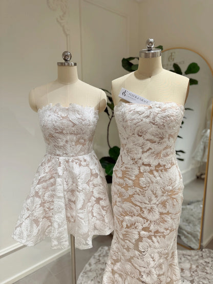 Strapless mermaid and short wedding dresses with white floral embroidery and glitter sequins on mannequins.