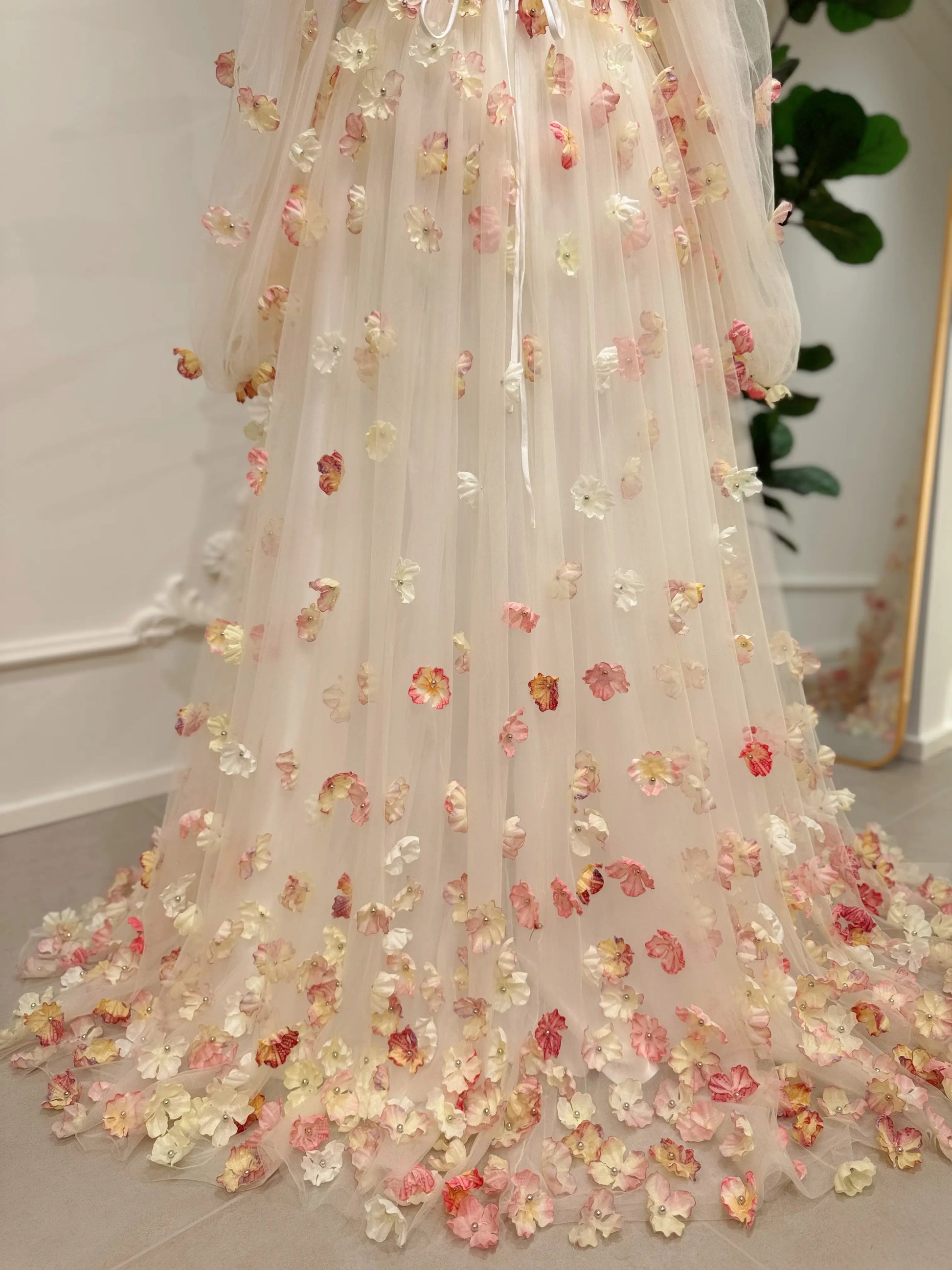 Pink floor-length gown featuring 3D floral appliqués, sheer tulle overlay, and removable sleeves for a romantic look.