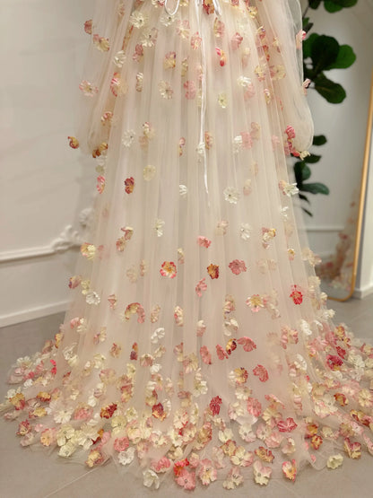 Pink floor-length gown featuring 3D floral appliqués, sheer tulle overlay, and removable sleeves for a romantic look.