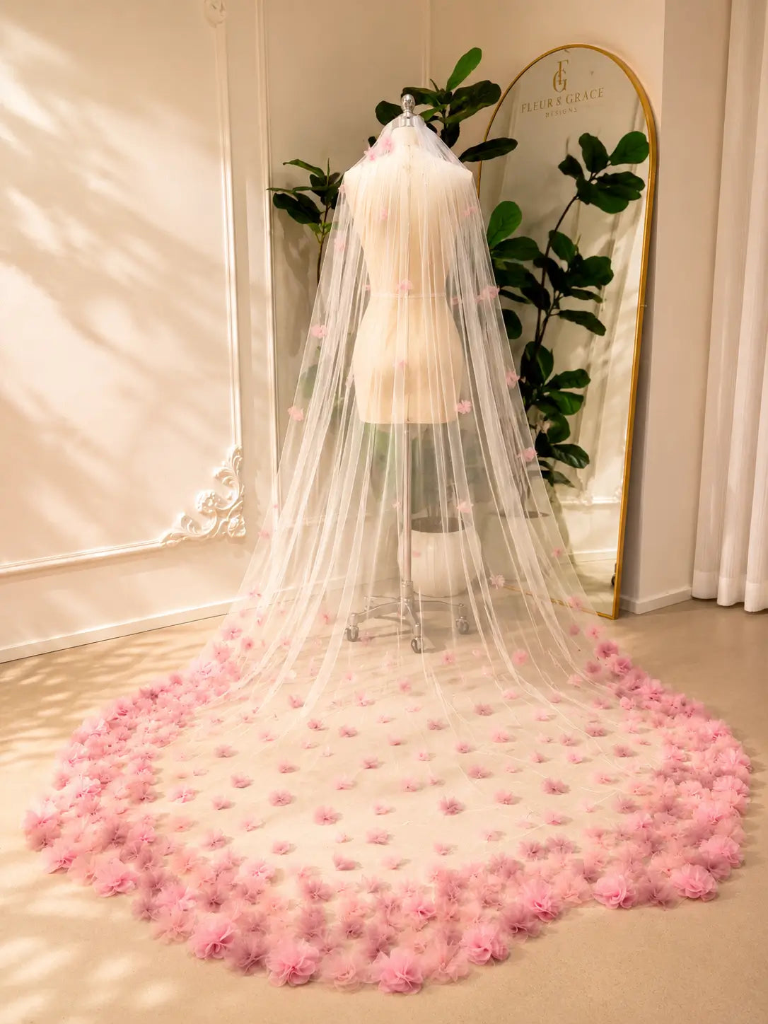 Cathedral-length bridal veil in soft illusion tulle featuring handmade blush pink 3D floral appliqués.