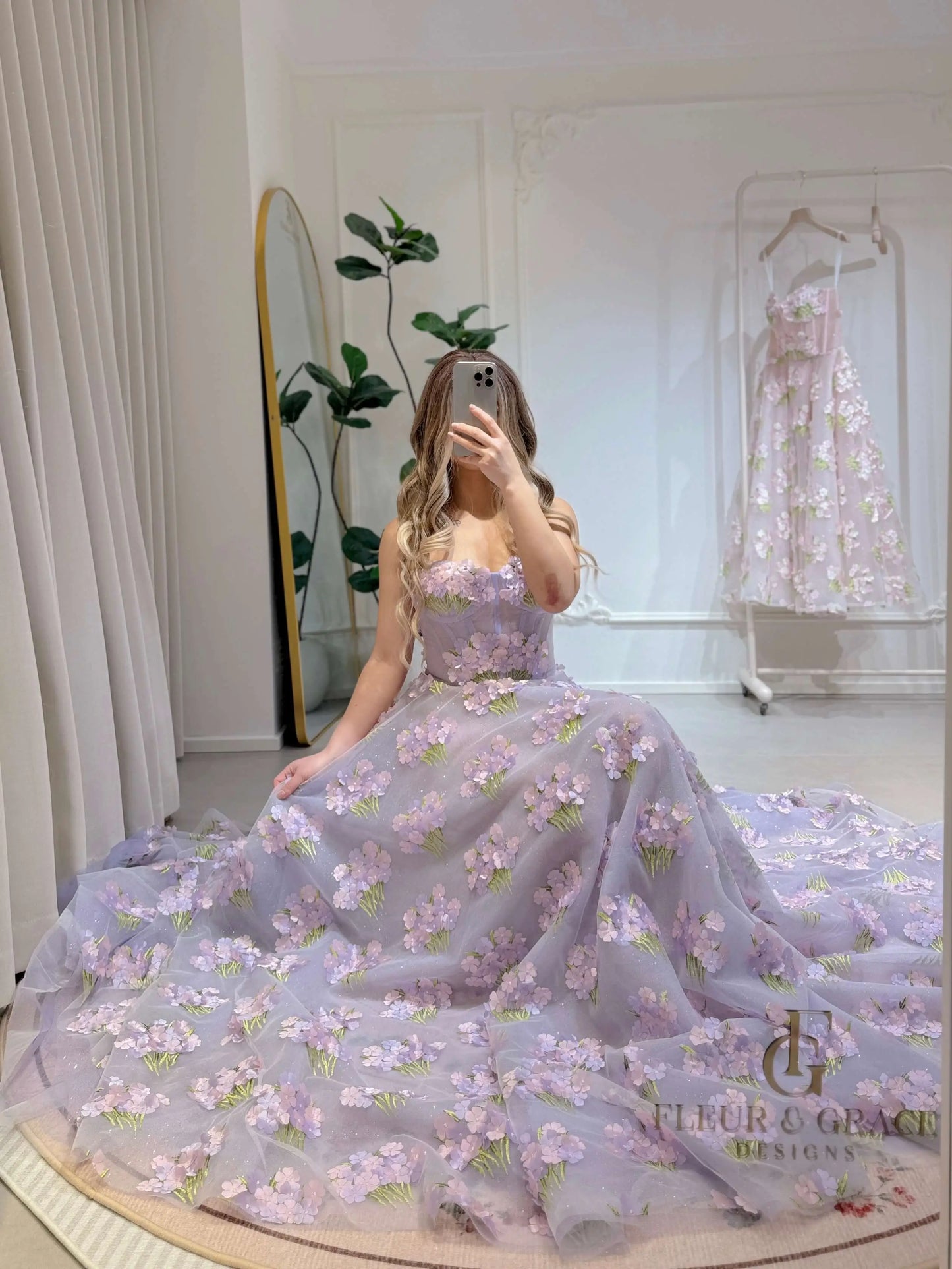 Lavender floor-length gown with 3D hydrangea floral lace, sweetheart neckline, and shimmering mesh skirt.