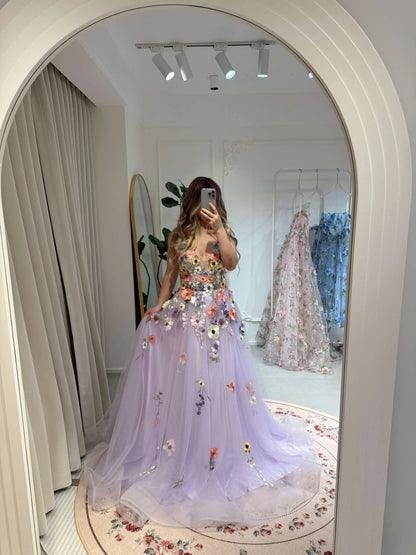 Lavender V-neck formal gown with floral embroidery, sparkly tulle skirt, and boned bodice in a mirror reflection.