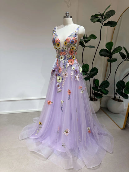 Lavender V-neck formal gown with sparkly tulle, floral embroidery, and a structured bodice on a mannequin.