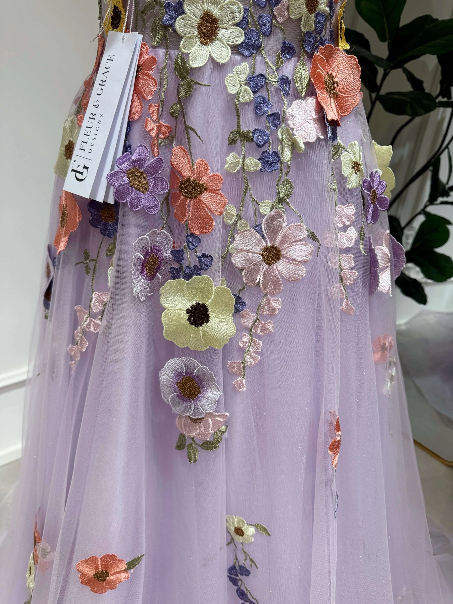 Lavender tulle formal gown featuring hand-sewn colorful wildflower embroidery and a sparkly layered skirt.