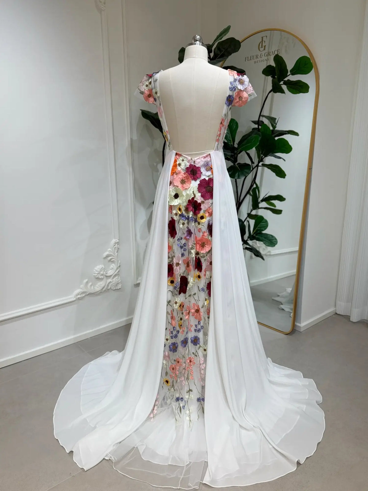 A-line chiffon wedding dress with an open back and vibrant floral embroidered panel cascading down the train.