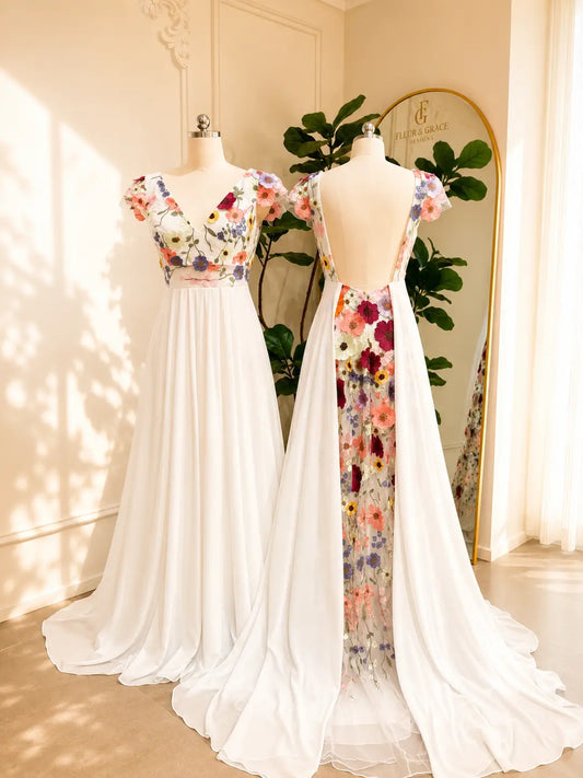 Chiffon A-line wedding dress with floral embroidered bodice, cap sleeves, and a dramatic open back with floral panel.