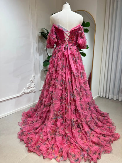 Pink floral tulle gown with ruffled layers, off-the-shoulder puff sleeves, and an adjustable lace-up corset back.
