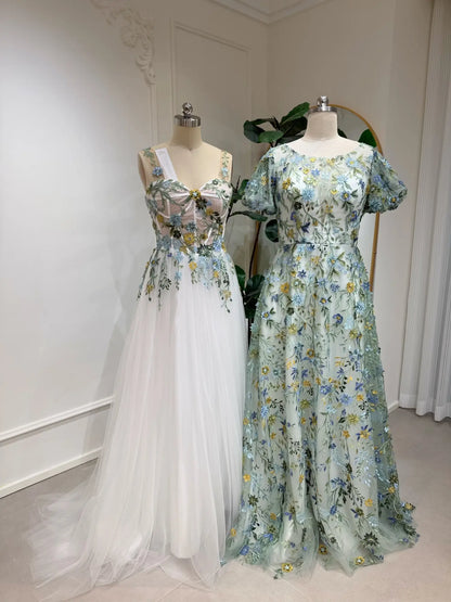 Meadow green floral embroidered tulle wedding gowns with puff sleeves and romantic A-line silhouettes on mannequins.