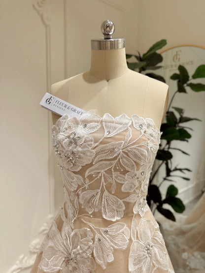 Strapless Mira wedding gown in nude tulle with ivory floral embroidery and handmade rhinestone embellishments.
