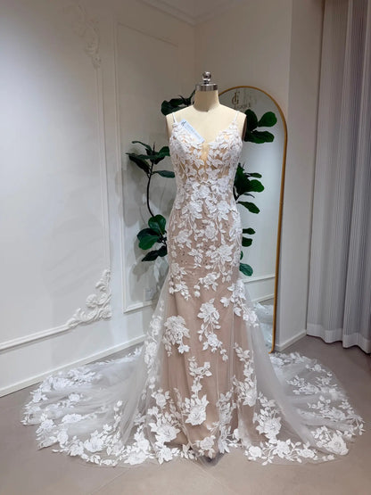 Nola mermaid wedding dress with floral lace appliqué, nude illusion lining, and a graceful lace-trimmed train.