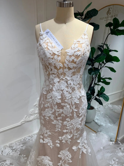 Nola mermaid wedding dress featuring white floral lace appliqué over a nude illusion bodice and tulle skirt.