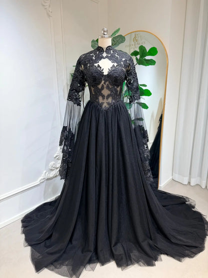 Black gothic wedding dress with intricate lace corset bodice, sheer detachable sleeves, and a flowing A-line tulle skirt.