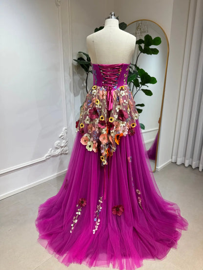 Magenta corset gown with 3D floral appliqués, lace-up back, and voluminous layered tulle skirt on a mannequin.