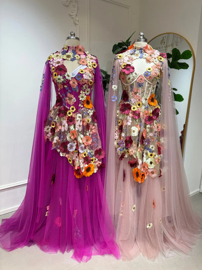 Two Odette floral corset ball gowns in pink and magenta with 3D floral appliqués, tulle skirts, and detachable cape sleeves.