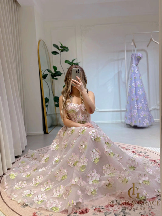 Pink ankle-length gown with 3D hydrangea floral lace, sparkly lining, and a structured bodice, worn by a woman.