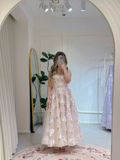 Pink ankle-length gown with 3D hydrangea floral lace, sparkly lining, and a structured bodice, reflected in a mirror.