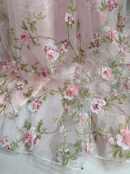 Pink organza gown fabric with 3D floral lace, green leaf prints, and shimmering sparkly mesh overlay.