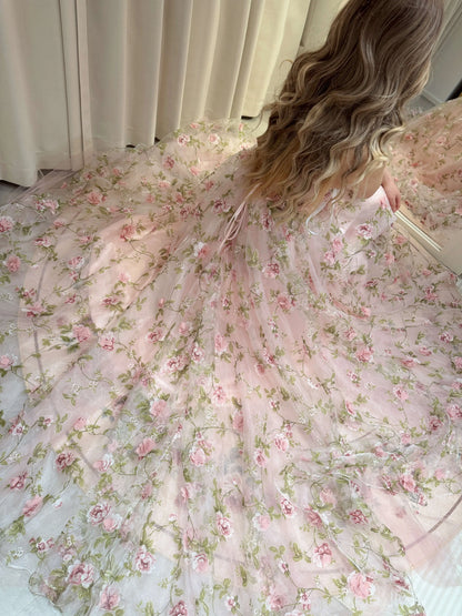 Pink Rosa gown with 3D floral organza lace, meadow green leaf prints, and sparkly mesh overlay on a full skirt.