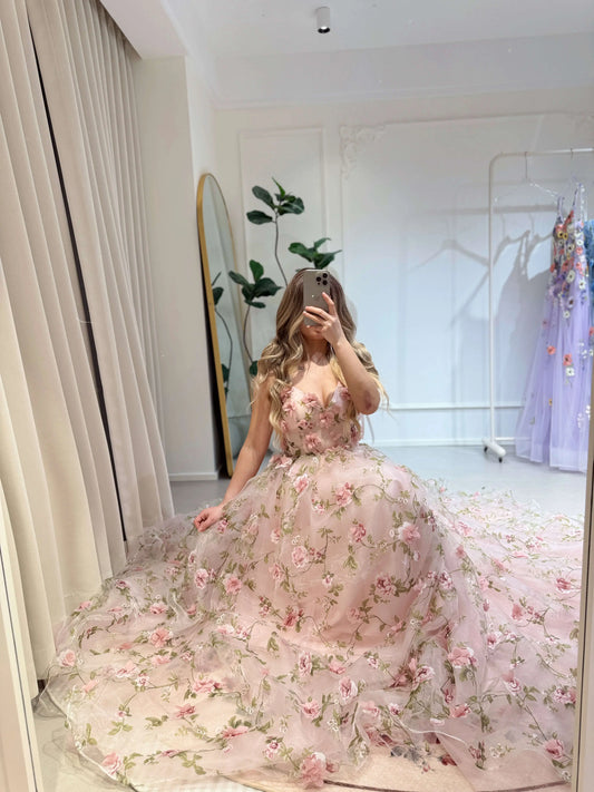 Pink Rosa gown featuring 3D floral organza lace, sweetheart neckline, and a voluminous skirt with green leaf prints.