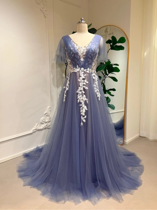Dusty blue A-line wedding dress with white floral lace appliqués, V-neck illusion bodice, and romantic flutter sleeves.