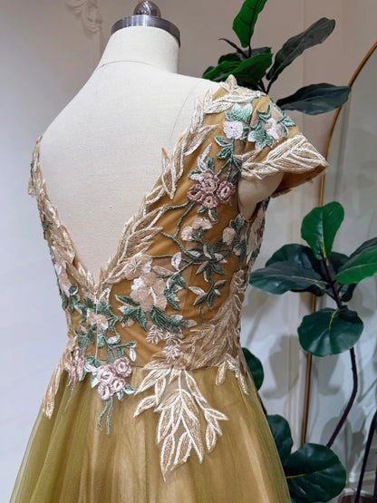Olive green tulle wedding dress featuring an illusion V-neck bodice with intricate botanical floral embroidery.