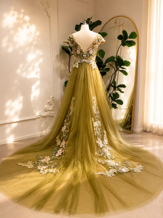 Olive green A-line wedding dress with floral embroidery, V-neck illusion bodice, and a dramatic long tulle train.