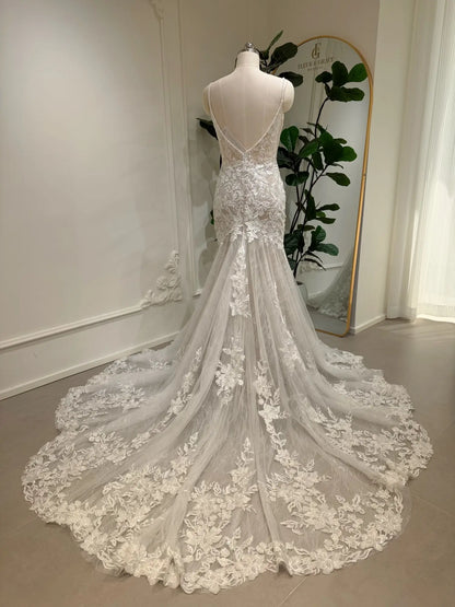 Selin ivory mermaid wedding dress with a low V-back, intricate floral lace appliqués, and a dramatic chapel-length train.