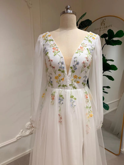 Stacey A-line wedding dress with pastel floral embroidery, deep V-neck, and airy chiffon bishop sleeves on tulle.