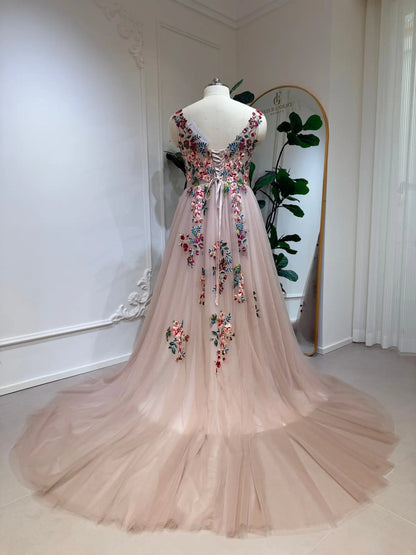 Blush A-line wedding dress featuring colorful floral embroidery, an illusion V-back, and a romantic lace-up corset closure.
