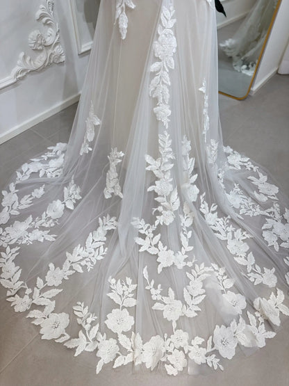 Ivory floral lace wedding dress with a court-length train and beige silk lining, featuring intricate beaded embroidery.