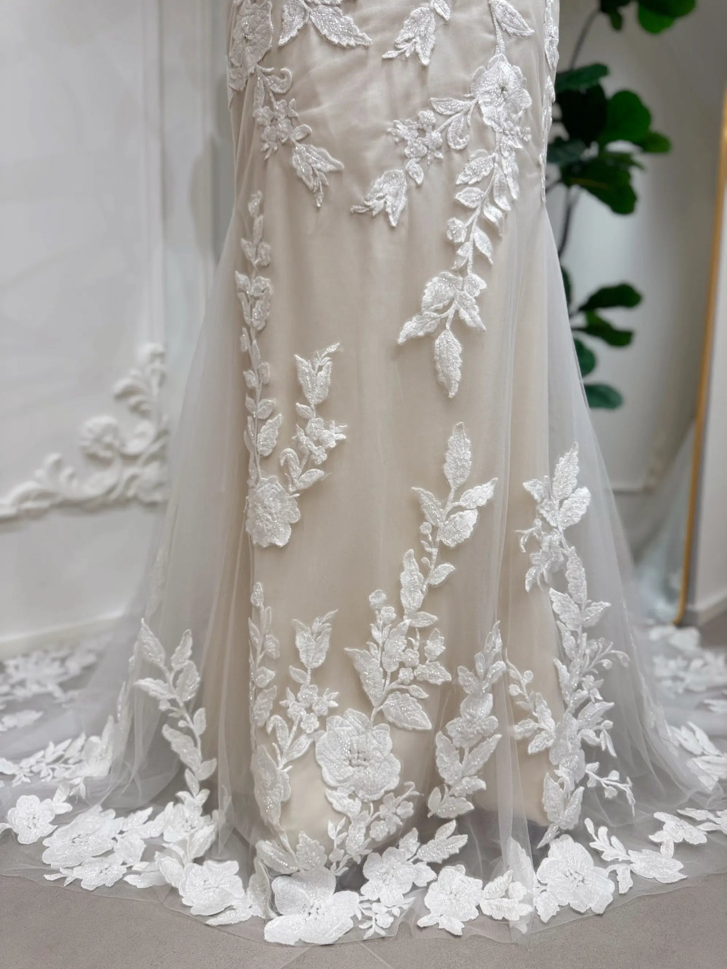 Tia Gown  by Fleur&Grace Designs — strapless mermaid wedding dress with basque waistline, sheer boned bodice, beige silk lining, ivory floral embroidery with beading, plunging V-neck, and court train.