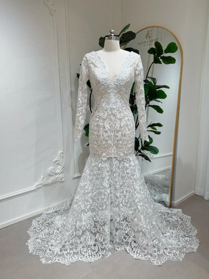 Beaded lace mermaid wedding dress with long sleeves, illusion V-neckline, and a dramatic scalloped chapel train.