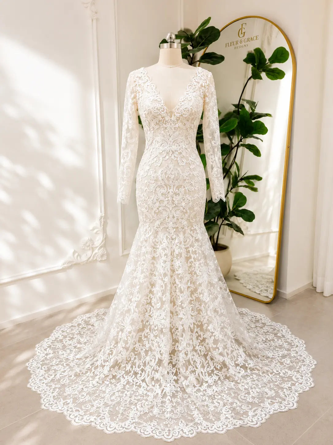 Beaded lace mermaid wedding dress with long sleeves, illusion V-neckline, and a scalloped chapel train.